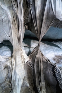 Aerial view ripped protective tarpaulin over Rhone Glacier Switzerland