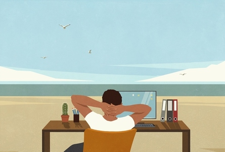 Carefree man at desk taking a break from working daydreaming of summer ocean beach