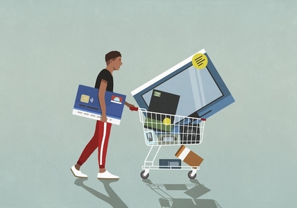 Male consumer with credit card pushing shopping cart with technology merchandise
