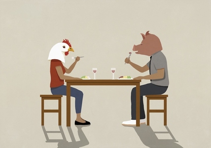 Couple wearing pig and chicken heads eating dinner at dining table