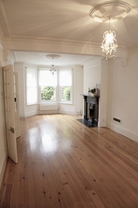 Empty room with fireplace and bay window