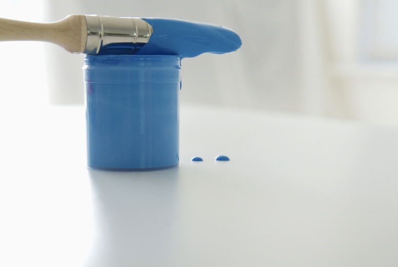 Blue paint tester and dripping paint brush