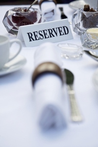 Close up of breakfast table with napkins and reserved sign