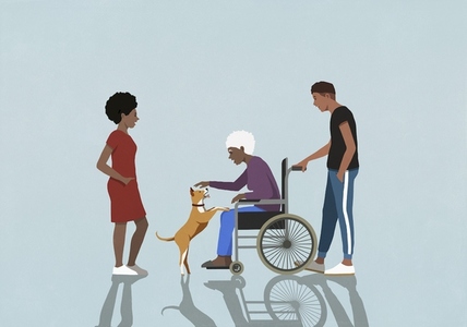 Adult children watching senior mother in wheelchair playing with dog