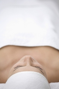 Close up of young woman lying on back and relaxing after beauty treatment