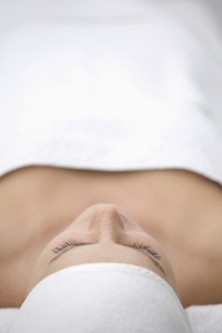 Close up of young woman lying on back and relaxing after beauty treatment