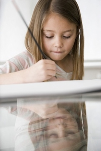 Close up of young girl writing