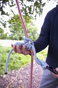 Close up of climber hands holding and checking climbing rope