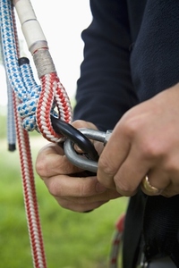 Close up of climber hands holding carabina key ring