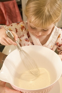 Young girl baking in kitchen