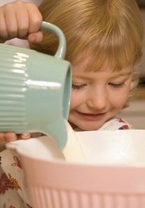 Young girl baking in kitchen