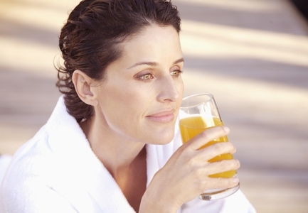 Woman smiling and drinking apple juice