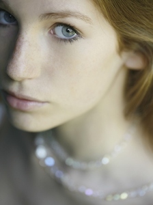 Close up of young beautiful woman with necklace