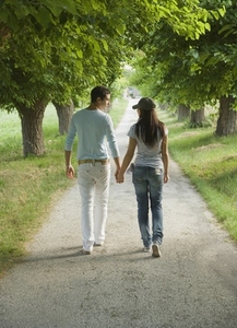 Young couple walking holding hands