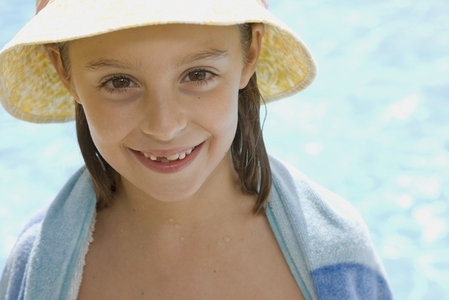 Young girl with hat and towel around shoulders