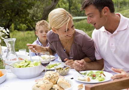 Couple and young boy having lunch outside