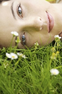 Young woman laying on a field of flowers
