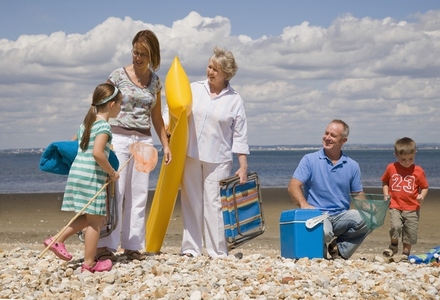 Portrait of multigenerational family leaving beach