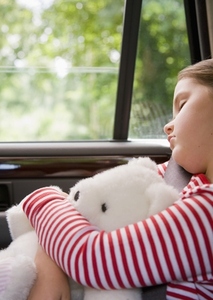 Portrait of young girl sleeping and cuddling teddy bear