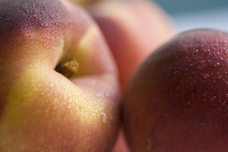 Extreme close up of three peaches