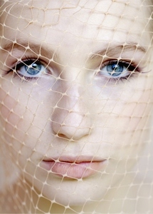 Extreme close up of young beautiful woman wearing net on face