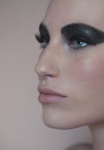 Close up profile of beautiful young woman with black eyeshadow