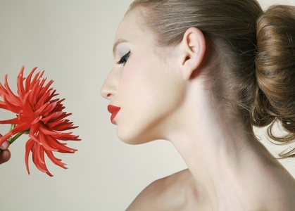 Young woman holding red dahlia