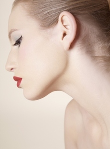 Close up profile of beautiful young woman with red lipstick