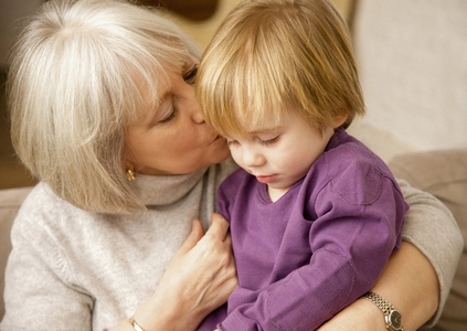 Grandmother kissing grandchild