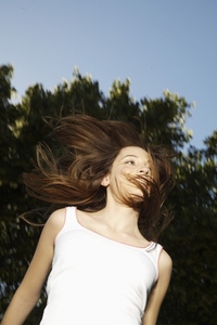 Portrait of a young woman jumping mid air