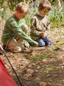 Portrait of two boys building a tent