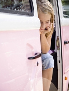 Portrait of a young girl sitting in a pink van