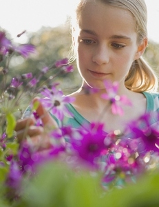 Close up of young girl admiring flowers