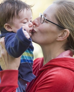 Close up of a woman kissing a little boy