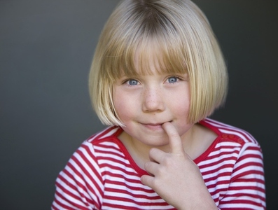 Portrait of a young girl with finger in her mouth