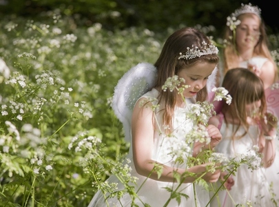 Young girls in fancy dress in a flower garden
