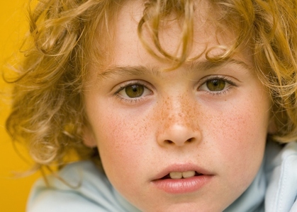 Close up of a young boy with curly hair