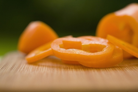Sliced orange peppers on a chopping board
