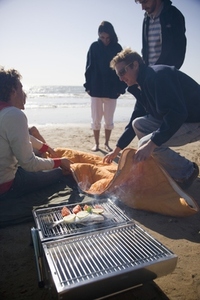 Friends having a barbeque on the beach