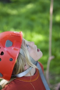 Young boy wearing a protective helmet looking up