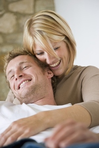 Close up of a young couple hugging and smiling