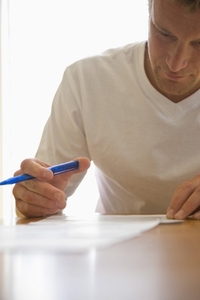 Close up of a man signing documents