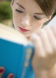 Close up of a teenaged girl reading a book