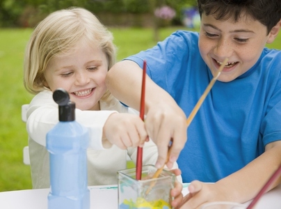 Young boy and young girl painting and smiling