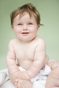 Portrait of a baby on green background