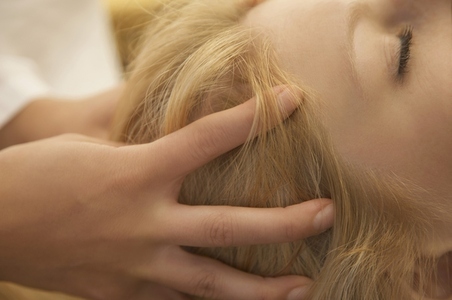 Extreme close up of woman head receiving scalp massage