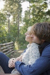 Profile of a young couple sitting and hugging