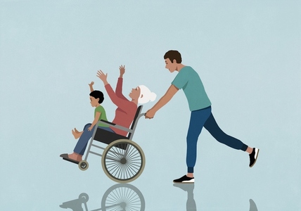 Playful man pushing happy mother and son in wheelchair