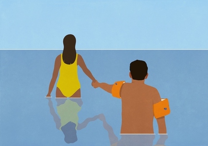 Wife holding hands with hesitant husband in water wings wading in ocean water