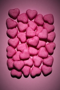 Still life pink heart candy on pink background